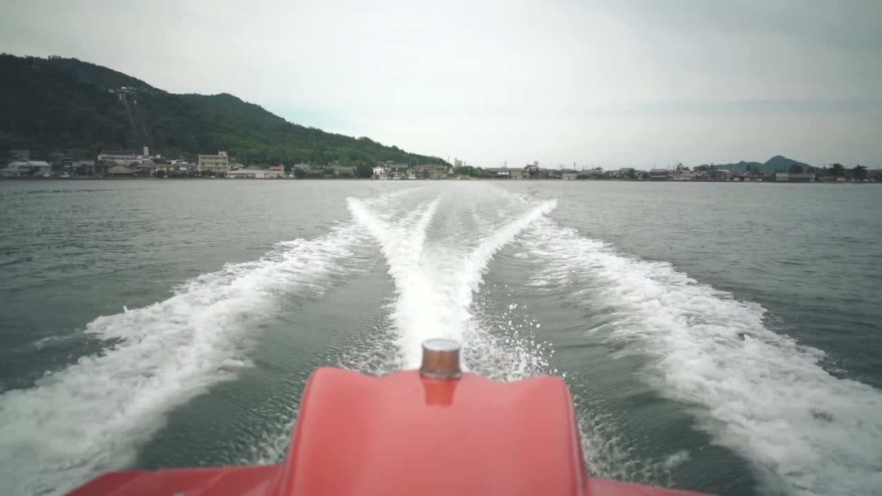 Motor Boat Cruising On The Calm Ocean And Leaving Water Trail In Kyoto, Japan. - wide shot