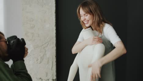 young woman having fun during studio photo shoot with mannequin