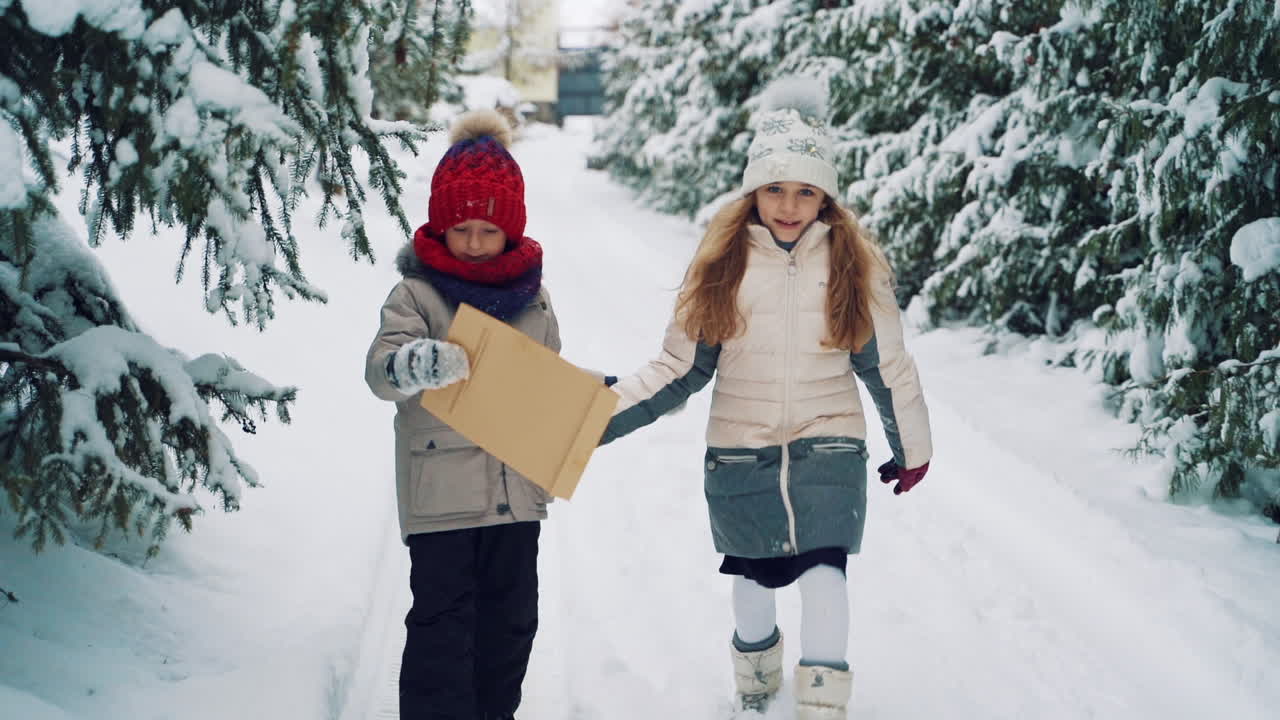 Children playing in winter park. Couple of child playing with snow in winter