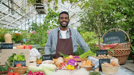 friendly farmer at a greenhouse market stall