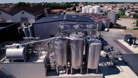 Aerial-drone-shot-above-steel-cylinder-in-a-industry-area