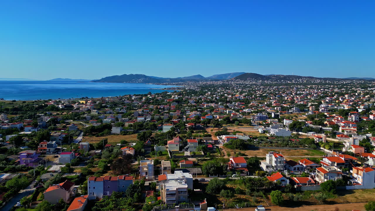 Aerial View of a Coastal Town with Red-Roofed Houses by the Sea