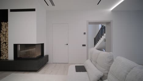 modern minimalist living room with a sleek fireplace, stacked wood storage, and clean white walls, reflecting a serene ambiance