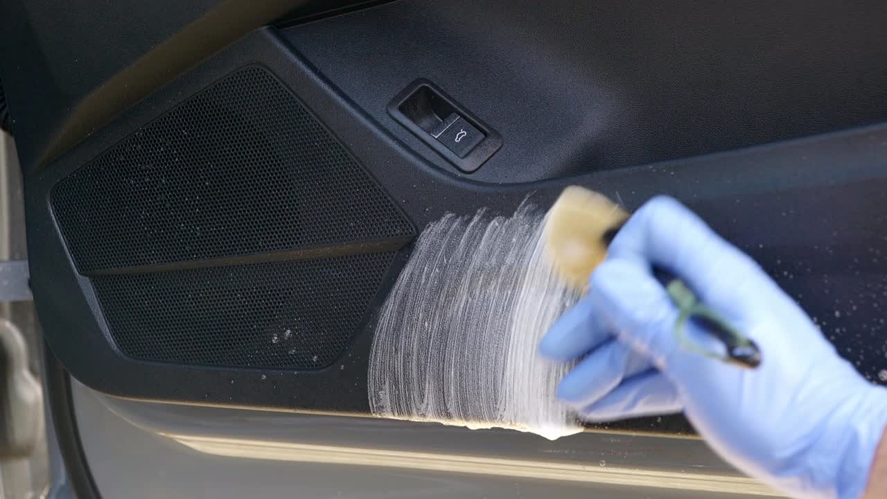 Cleaning interior car plastic door card with all purpose cleaner and brush up and down