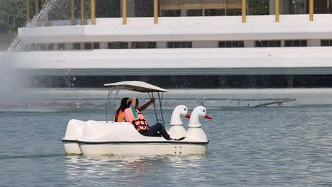 couple enjoys swan boat on serene lake