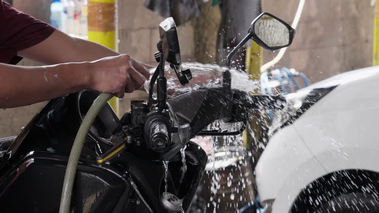 Giving a motorbike a thorough rinse with abundant water