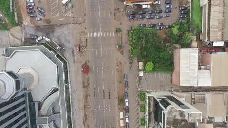 in this shot the yaounde city parade can be seen below [[as the drone quickly pans over the streets below