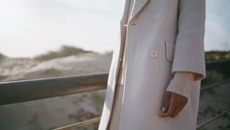 Woman-body-walking-pier-in-sunlight-closeup.-Peaceful-female-enjoying-beach