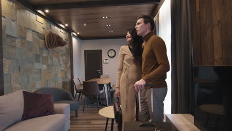 couple exploring modern cozy apartment