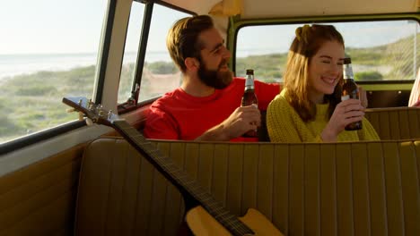 Happy-couple-having-beer-in-the-van-4k