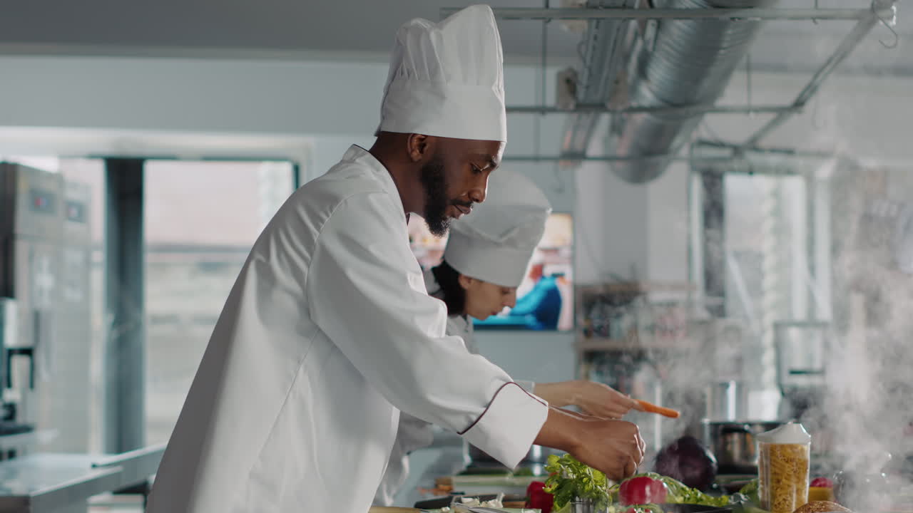 Professional cook preparing tasty meal with rosemary leaves