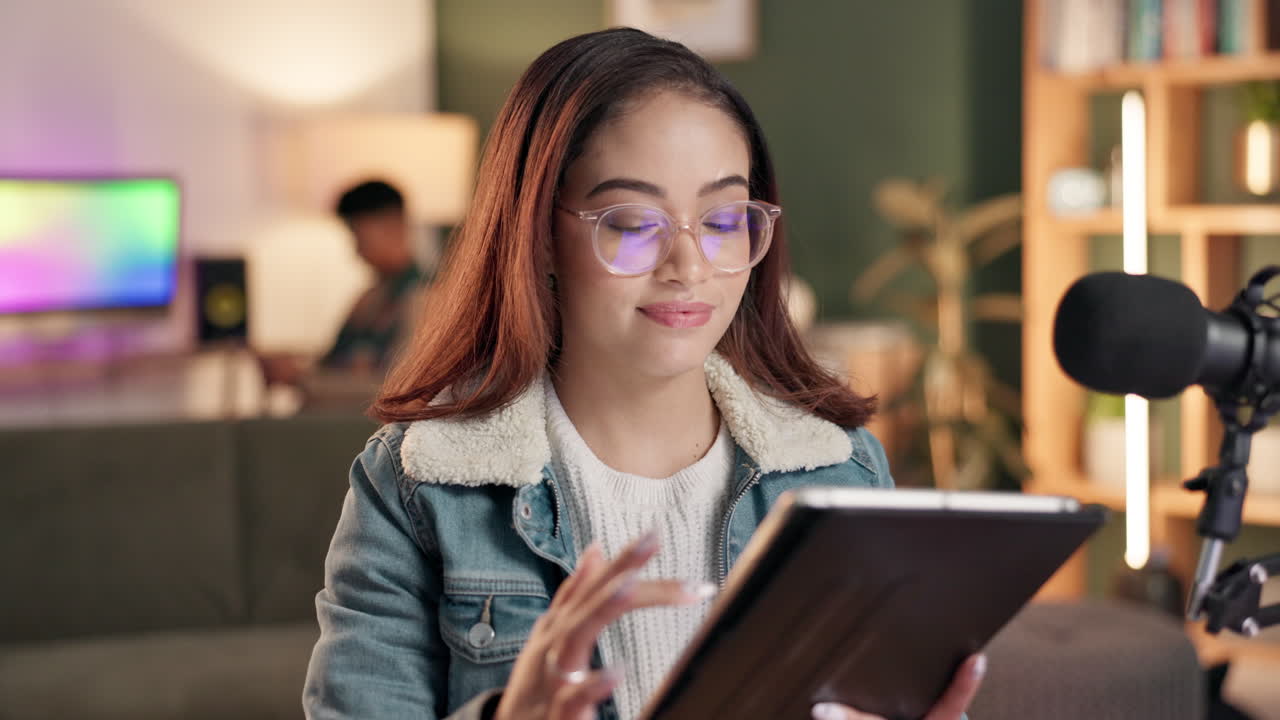 Woman using tablet with microphone in background