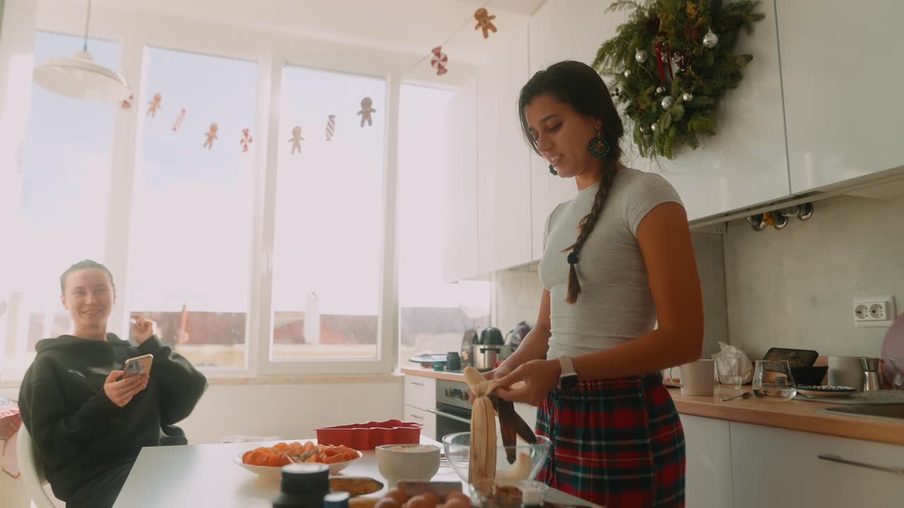 Women Cooking in a Kitchen Decorated for Christmas