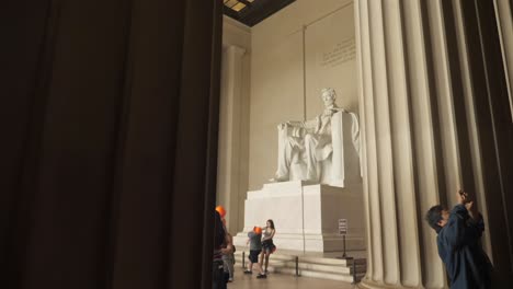 abraham lincoln memorial statue inside neoclassical temple, washington d.c., slow motion pan down reveal