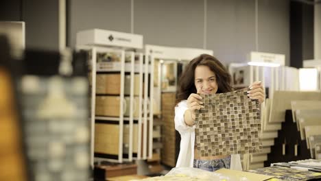 woman choosing mosaic tile in a showroom