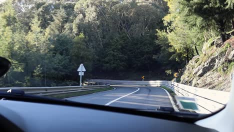 driving on road in serra da estrela natural park on steep winding roads with rocky cliff and guard railing
