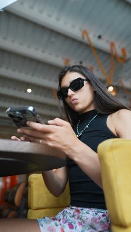 woman using a phone in a cafe