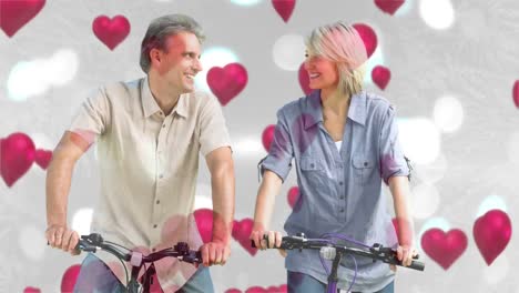 Happy-couple-smiling-while-cycling-