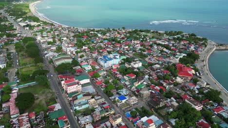 Rising-aerial-drone-shot-of-scenic-coastal-Philippine-town-in-Virac,-Catanduanes