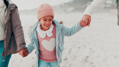 family enjoying a winter beach walk