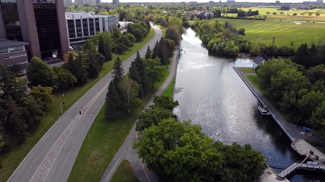 Drone video of Carleton University Campus next to Rideau Canal locks with farm fields in background