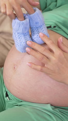 pregnant woman holding hands on belly. pregnant woman feeling happy with new life at home