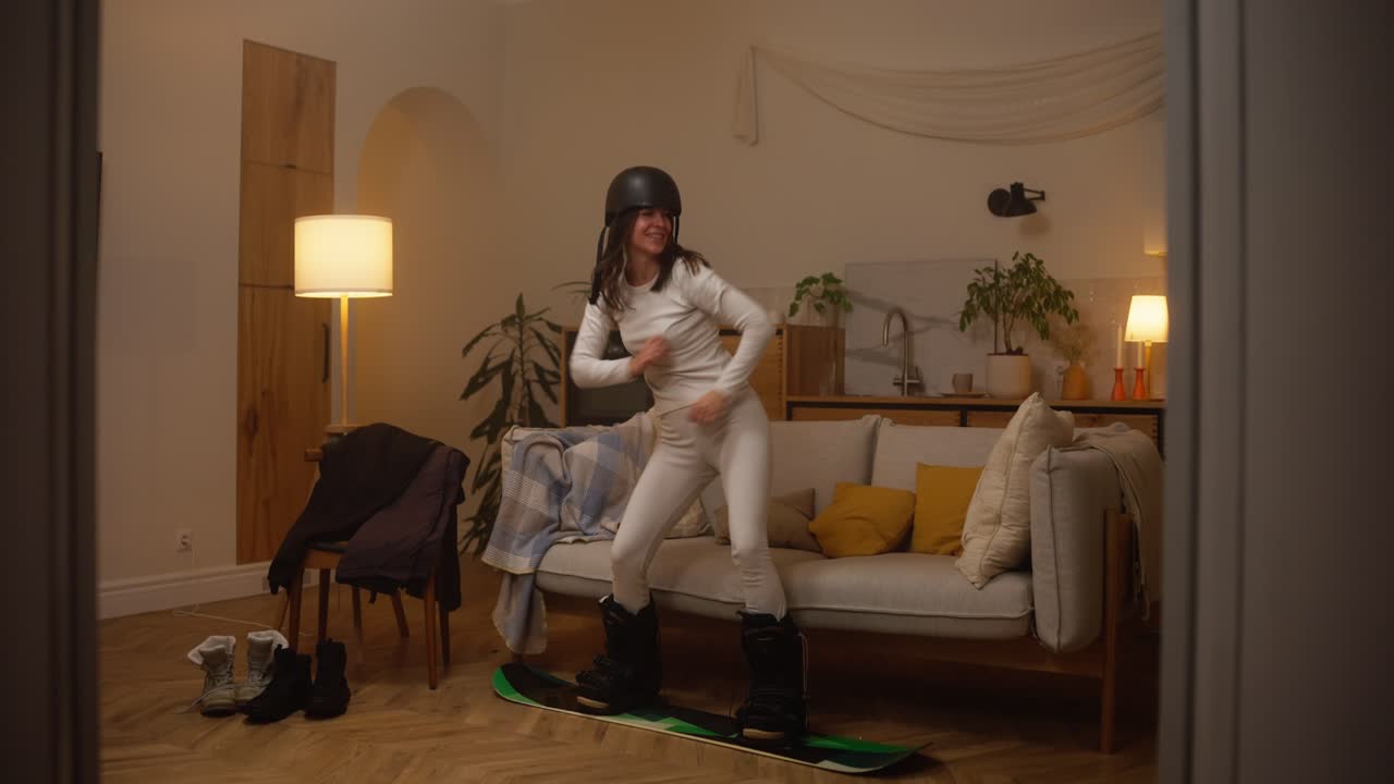 Woman having fun with snowboard inside