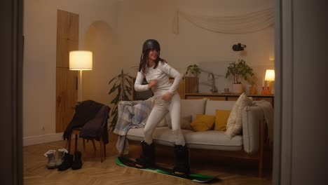 woman having fun with snowboard inside