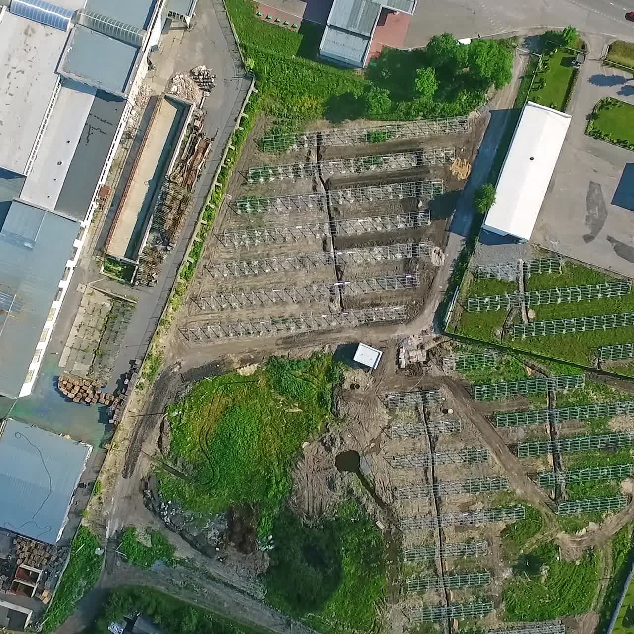 Slow descending on the area with installed metal constructions for solar panels. Renewable energy station building site