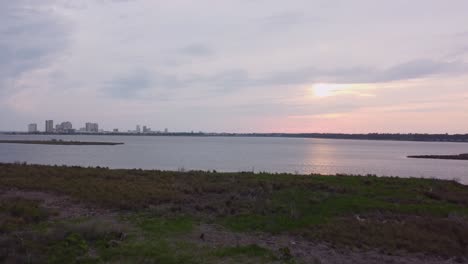 orange beach alabama skyline along coastline and marshland during sunset.