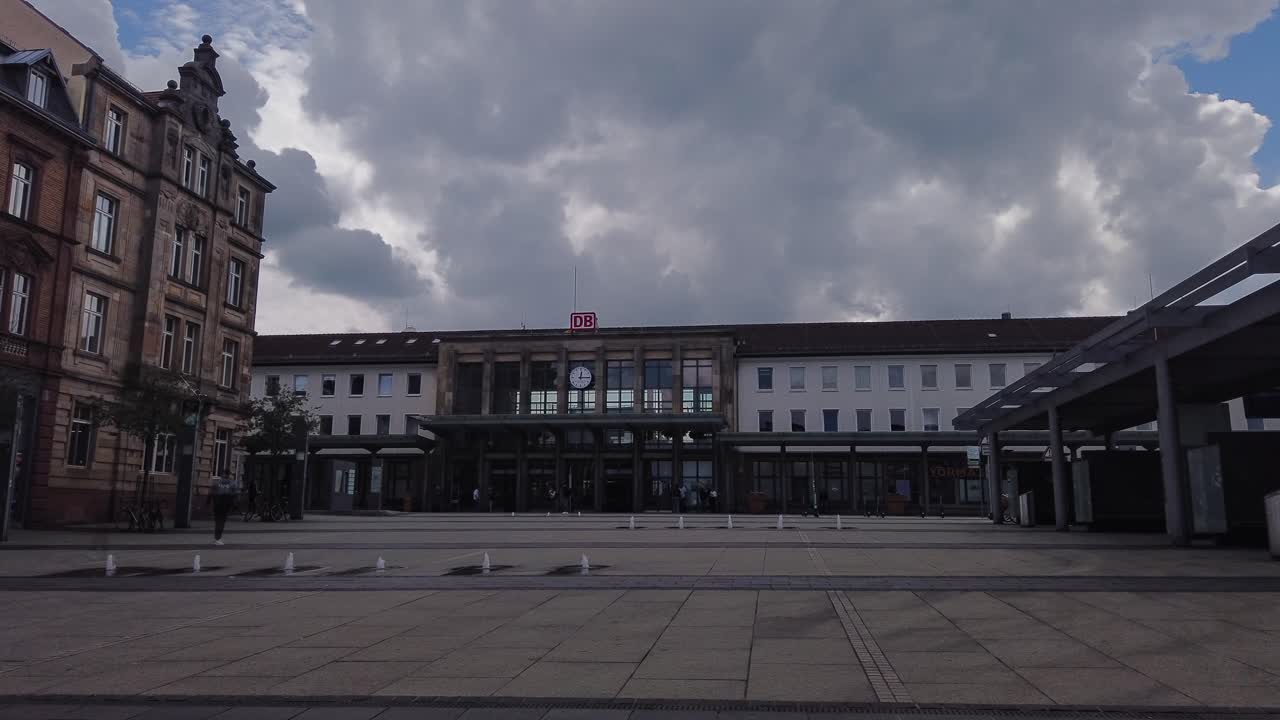 View of a German Train Station and its Public Square on a Cloudy Day