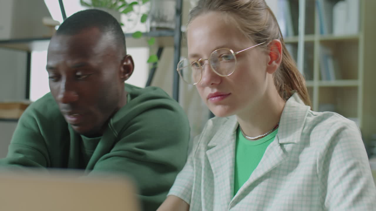Young Diverse Man and Woman Working Together in Office