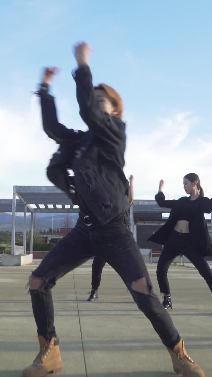 Young STREET PERFORMER performing on the street. Seven chinese teenagers dancing kpop