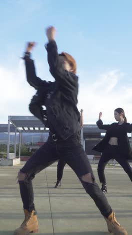 young street performer performing on the street. seven chinese teenagers dancing kpop