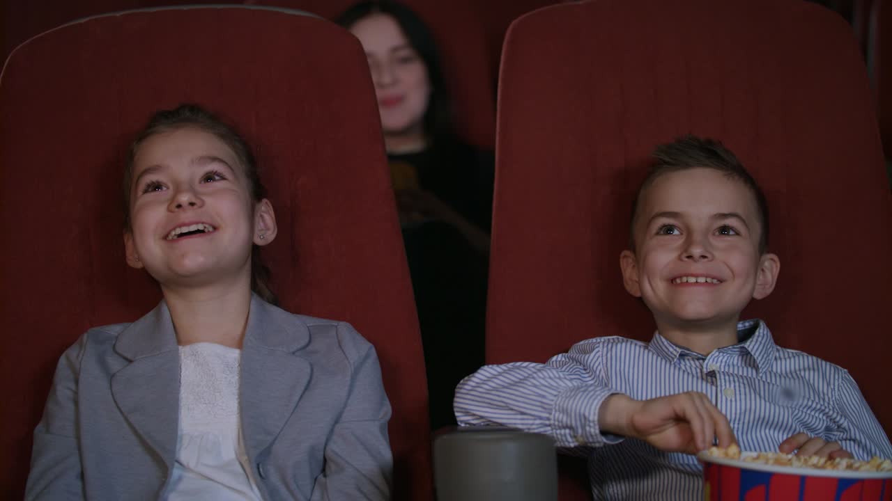Children laughing at cartoon cinema. Smiling child watching funny cartoon