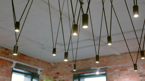 modern chandelier lighting in a brick interior