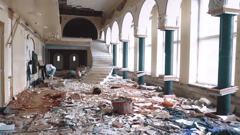 foreman-goes-on-a-construction-site-in-an-abandoned-building-and-studies-the-plan