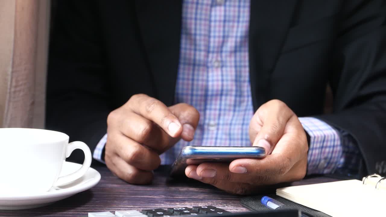 Businessman using a smartphone at a table