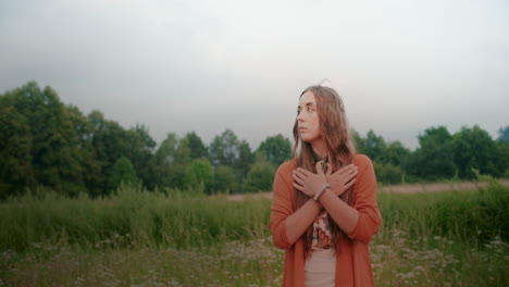 woman meditating in front of a forest and meadow looking for inspiration peace and inner peace