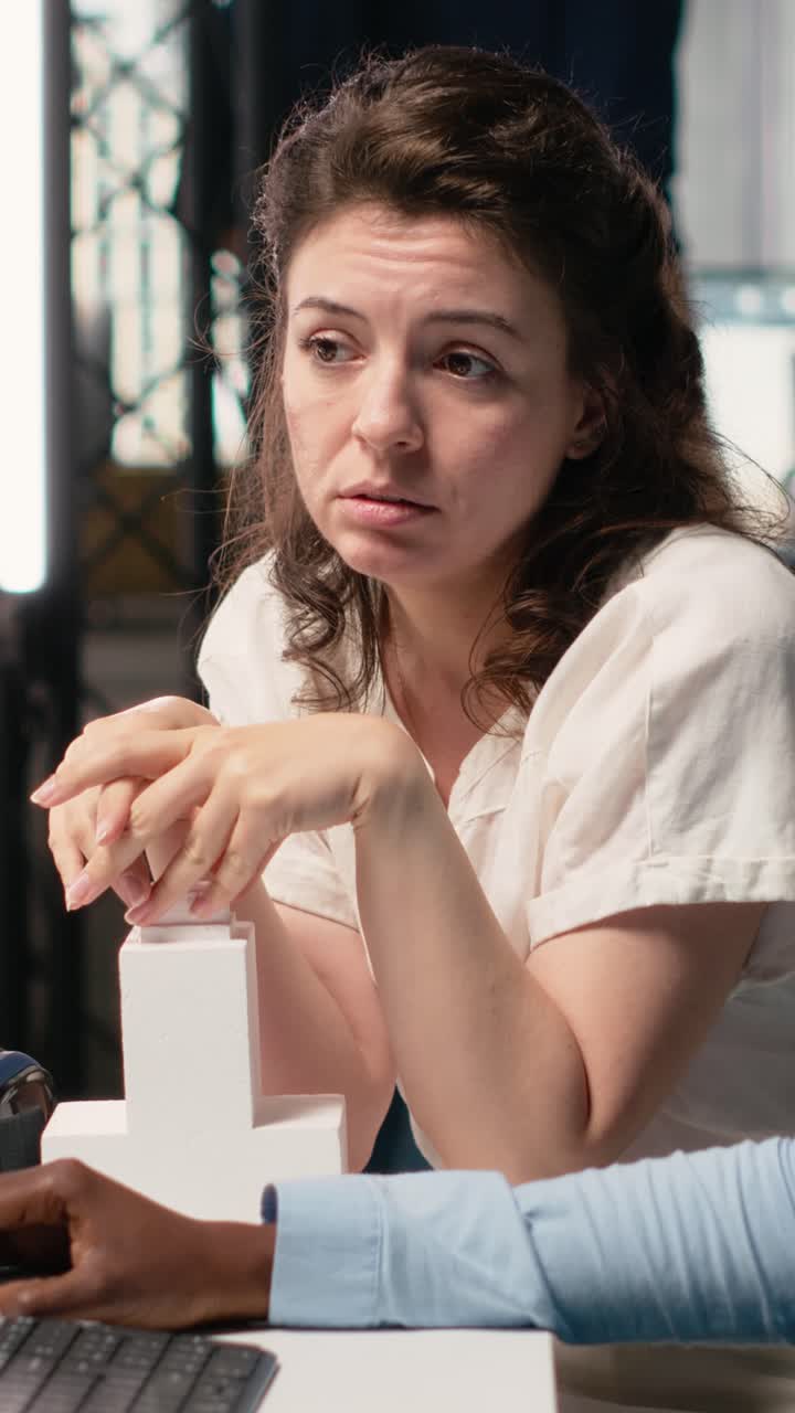 Vertical Video Two developers reviewing blueprints for real estate project planning