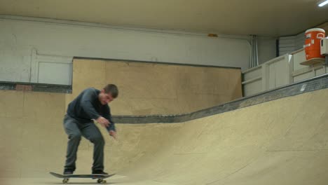 blunt frontside flip on an indoor skateboard ramp