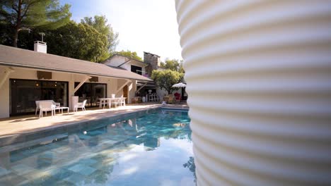 slow establishing shot of a private pool at a villa in vias, france