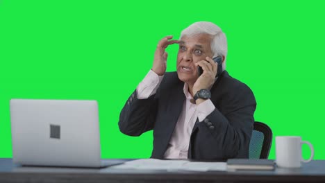 angry indian senior manager shouting on mobile phone green screen