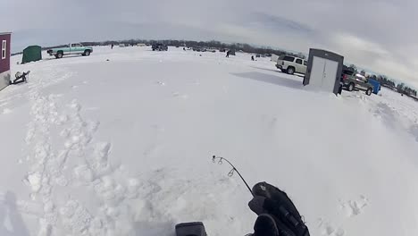 a person enjoying ice fishing outdoors - high-angle shot