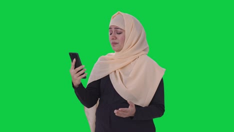 Angry-Muslim-woman-talking-on-video-call-Green-screen