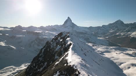 drone flies above swiss mountain ridgeline to reveal gornergrat