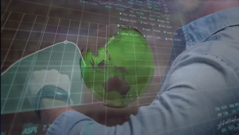 Man checking smartwatch in finance workspace, showing holographic globe and floating stock tickers