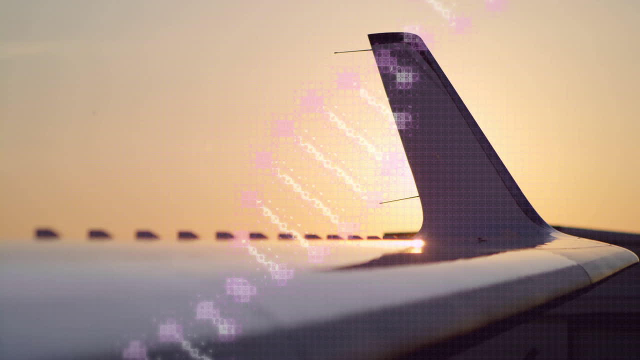 Sunset view of airplane wing with digital data animation overlay in sky