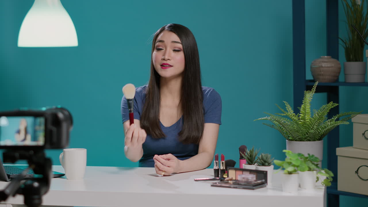 Beauty vlogger doing product review with makeup brush