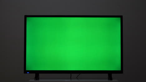 green screen tv in a room at night